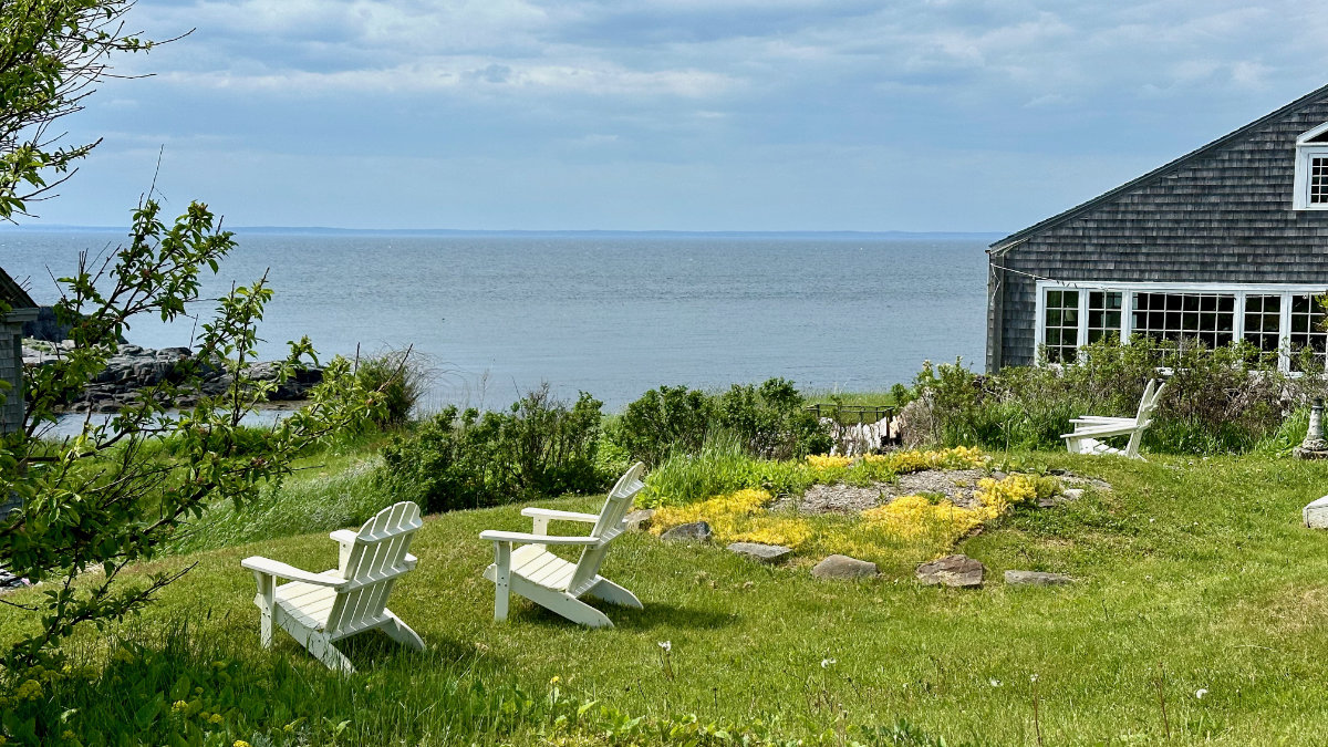 Adirondack chairs on a bluff overlooking Monhegan Harbor